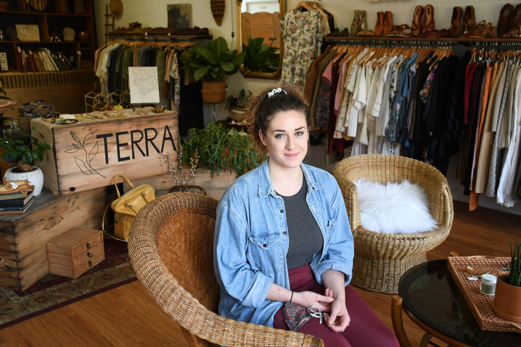 White sits on a chair in her boutique